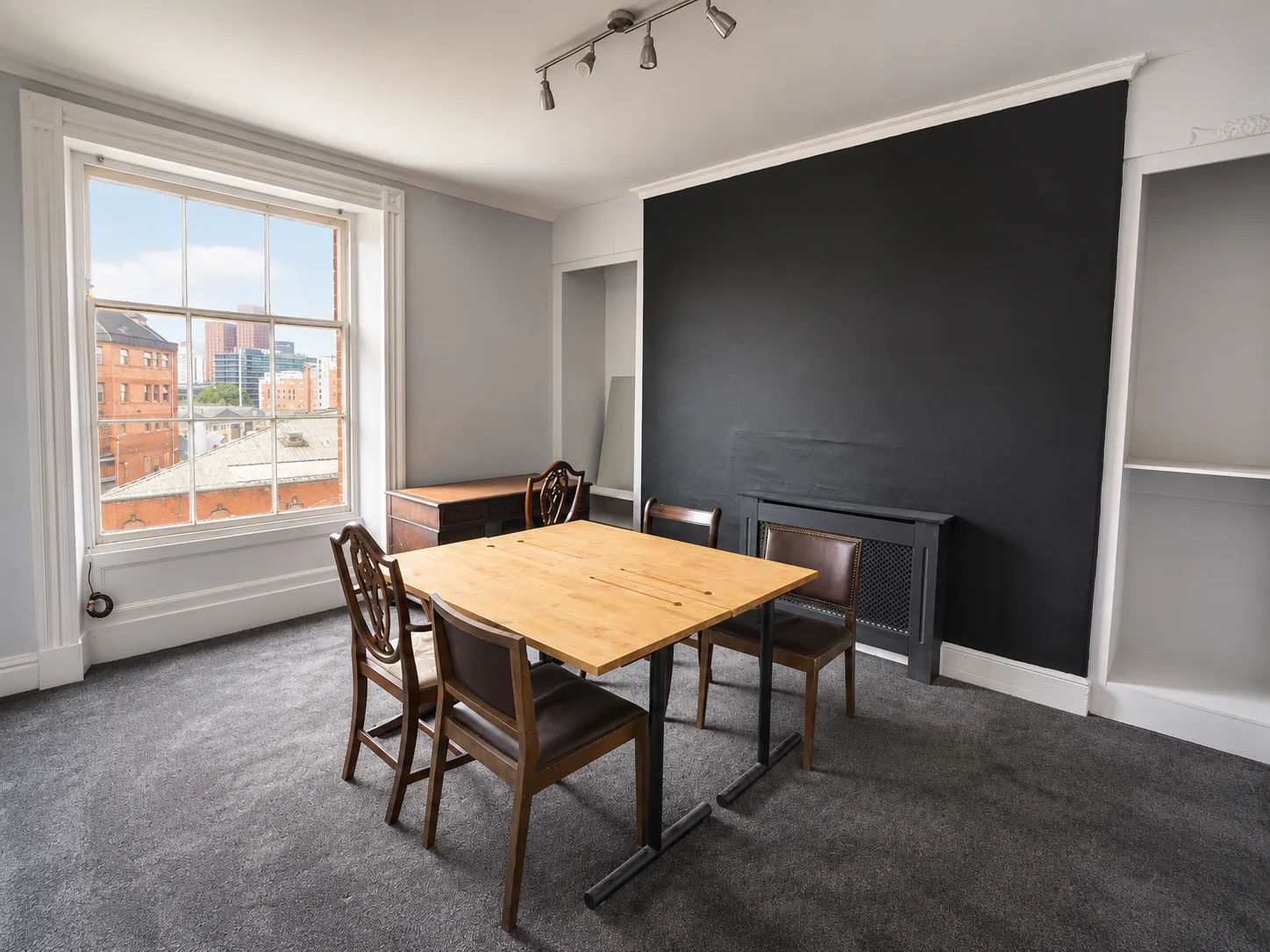Room 12 with a meeting table and view towards Manchester