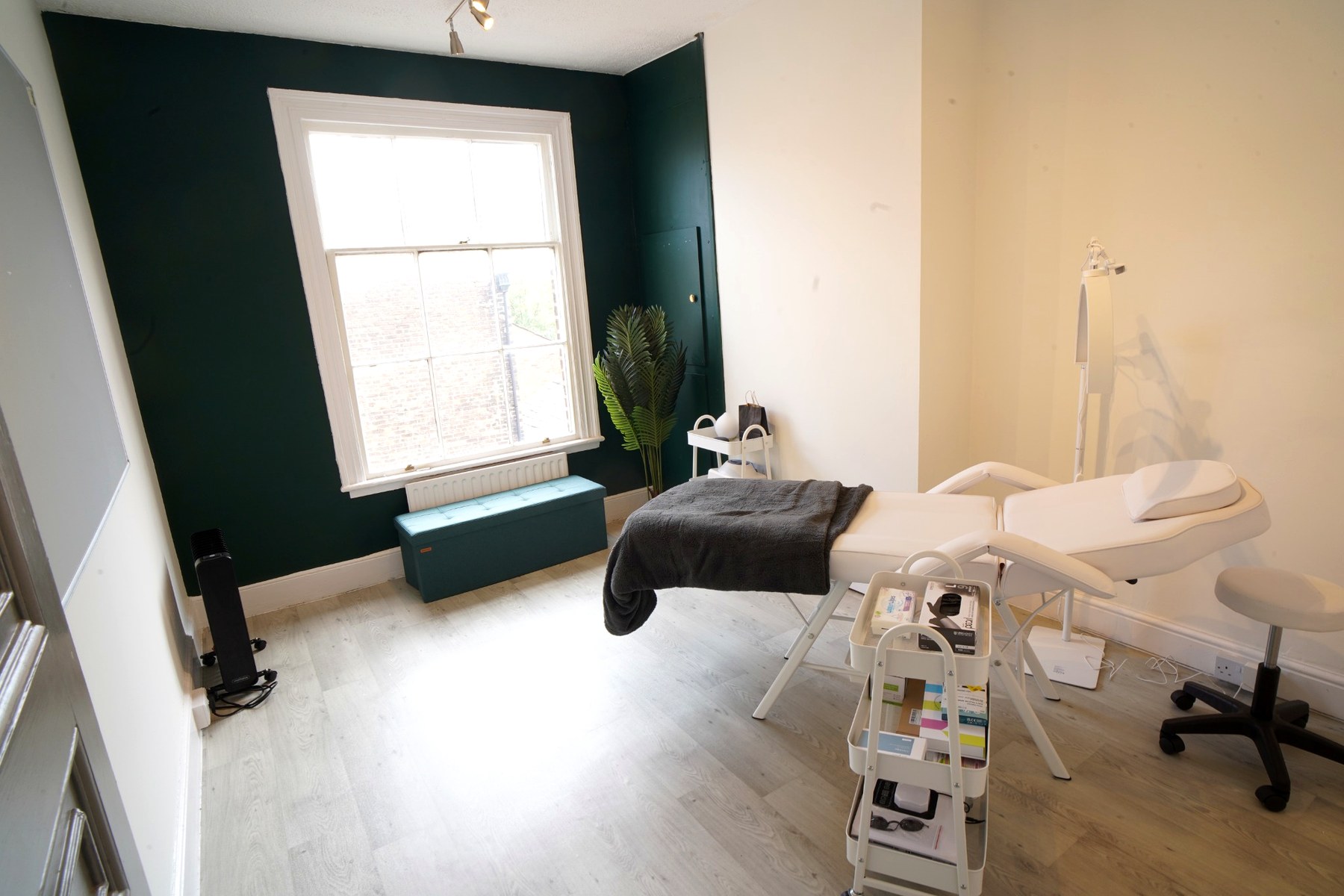 Room 13 set up as a bright treatment and consulting room